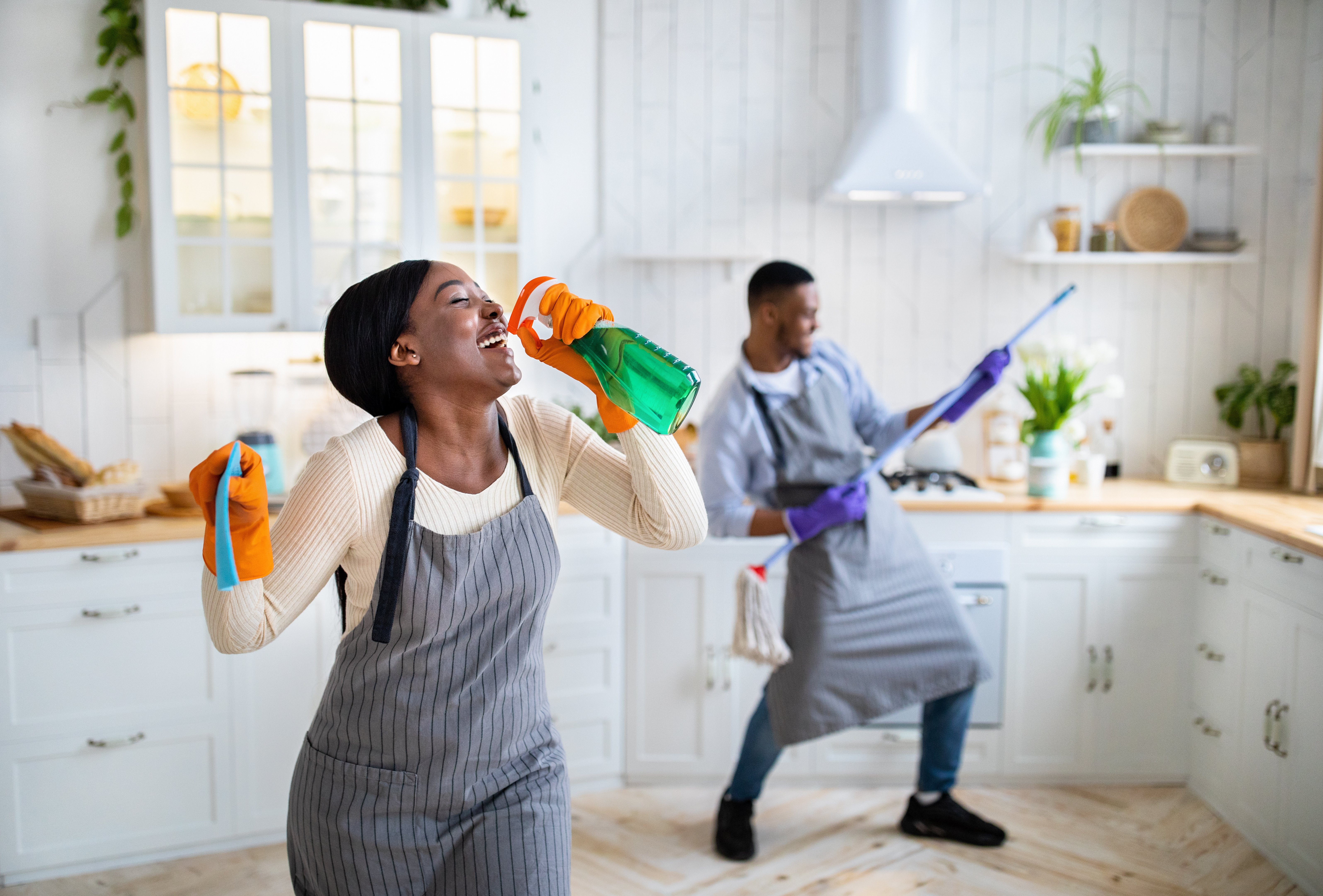 happy-black-lady-using-detergent-as-microphone-he-2023-11-27-05-17-10-utc