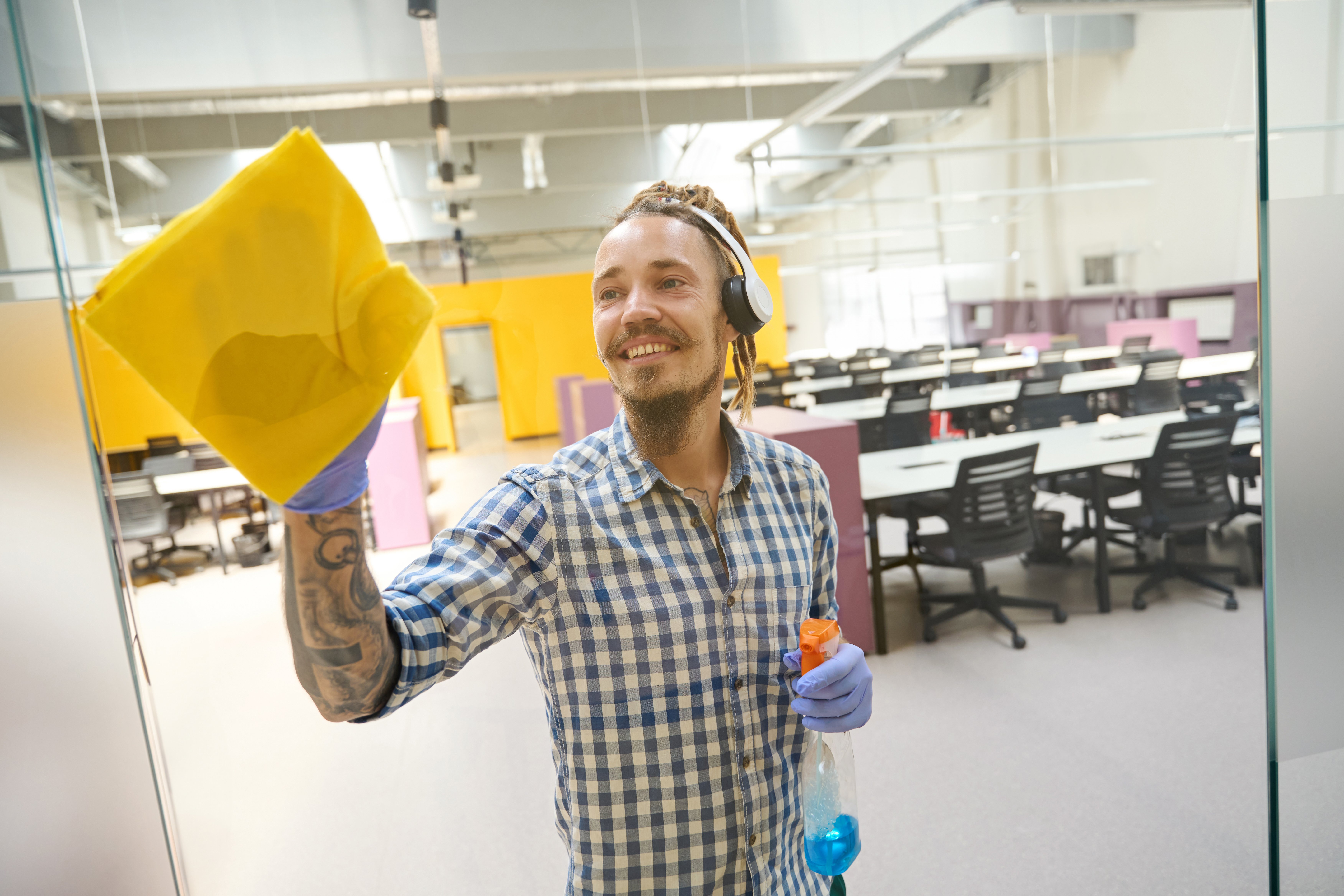 man-wearing-headphones-rubs-the-glass-with-a-yello-2024-10-20-19-39-33-utc